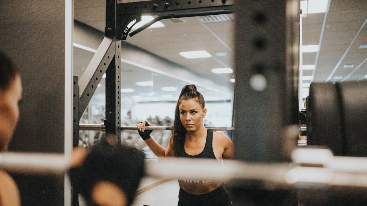 woman in black sports bra and black shorts doing exercise